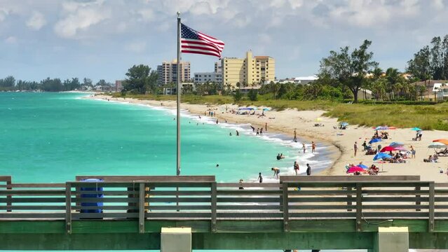 Aerial view of Venice fishing pier in Florida, USA. Many people enjoing vacation time swimming in gulf water and relaxing
