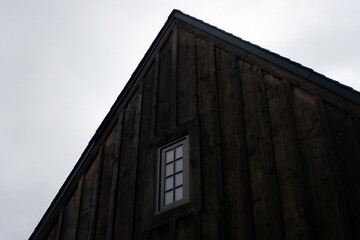Fototapeta na wymiar Shou Sugi Ban or surface charred wood cladding on a building with one window