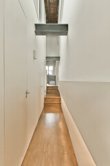 a long hallway with wood flooring and white walls in the room is very neat, but it's not too