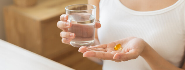 Dietary supplement, asian young woman, girl hand holding medical pill capsule, take or eat vitamin...