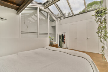a bed in a room with skylights on the ceiling and windows to the other rooms, including closets