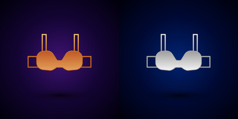 Gold and silver Bra icon isolated on black background. Lingerie symbol. Vector