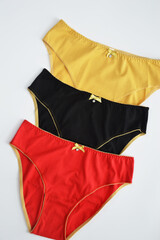 Lingerie. Set of women's colored cotton panties on a white background, top view. Women's underwear.
