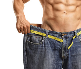 Shirtless muscular man wearing a big size jeans after weight loss