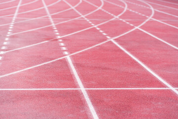Fototapeta premium Markings from curve and straight crossed lines on all-weather running track with rubberized surface at contemporary sports arena equipped place for joggers routine training