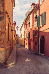 Fototapeta na wymiar Cozy narrow street in Ferrara, Emilia-Romagna, Italy.