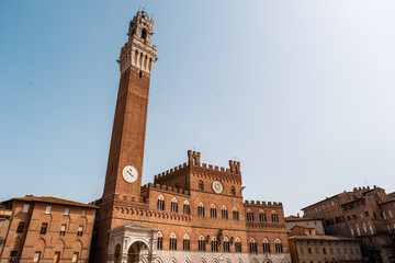 Fototapeta na wymiar The Palazzo Pubblico in Piazza del Campo, the central square of Siena, Tuscany, Italy.