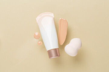 Composition with makeup foundation on color background, top view