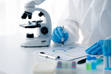 Hand of doctor or research scientist taking a test tube to check data in laboratory biotechnology specialist Ambitious new generation Works with advanced devices