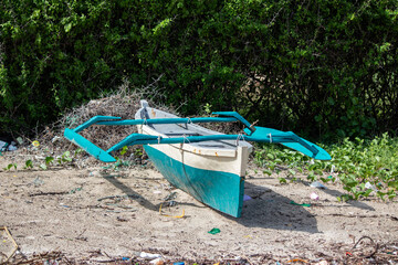 Typical wooden simple African villagers boat for fishing, made of local materials, at the shore of...