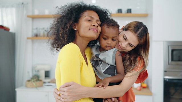 Lesbian Couple Moments Happiness With American African Adopted Child. Mixed Race Lesbian Couple. Lesbian Marriage And Adoption. Homosexual Family, LGBTQ Lifestyle