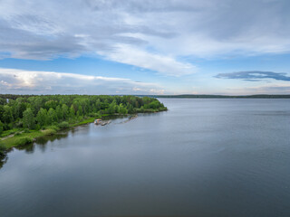 Big lake with green shores in bright sun light, aerial landscape. Recreation concept. Aerial view