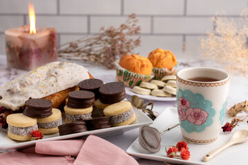 breakfast and snack with tea and coffee with cornstarch and chocolate alfajores with mini donuts and muffins