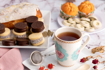 breakfast and snack with tea and coffee with cornstarch and chocolate alfajores with mini donuts and muffins