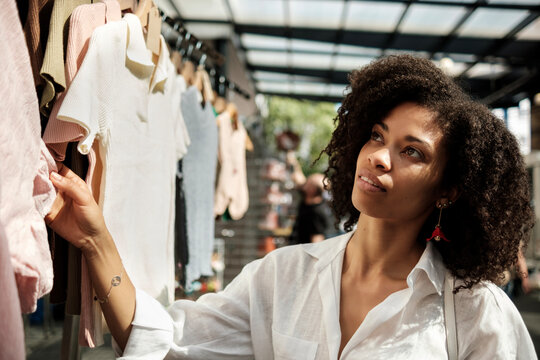 Black Woman Looking Outfits In Street Market.