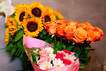 A beautiful flower arrangement of fresh blooms, sunflowers and orange roses, bouquet capturing the essence of natures beauty and floristry art.