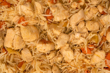 Tasty pilaf with chicken as background.