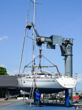 The yacht lifted ashore by a sailboat lift for the maintenance of the underwater part of the hull
