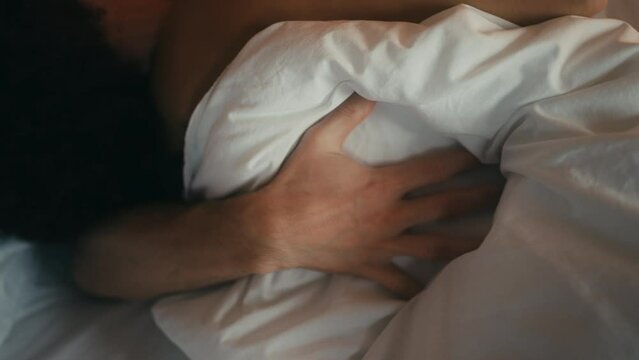 Closeup of couple kissing and hugging in bed, relationship, marriage, intimacy