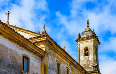Fototapeta na wymiar Detail of the windows and tower of an old baroque church in the city of Ouro Preto