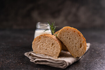 Homemade whole grain brown buns with sesame seeds on rustic background. Healthy artisan bread.