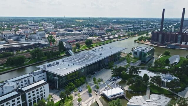 Drone shot of a modern glass building in autostadt , Wolfsburg , Germany