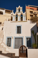 Fototapeta na wymiar Beautiful Small Blue Orthodox Church with Bell Tower - Fira, Santorini Island, Greece