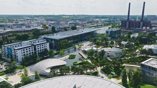 Drone shot of a modern glass building in autostadt , Wolfsburg , Germany