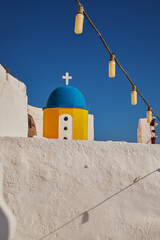 Colorful Small Yellow Churc - Blue Dome with Hanging Lights - Oia Village in Santorini Island, Greece - Sunset