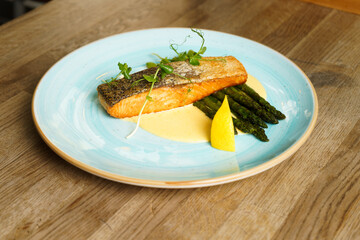 Grilled fillet of Salmon with steamed green asparagus, hollandaise sauce