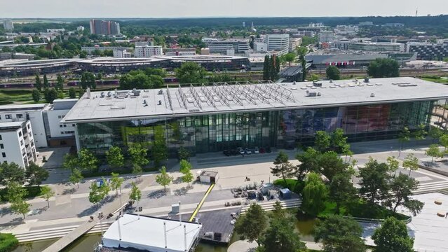 Drone shot of a modern glass building in autostadt , Wolfsburg , Germany