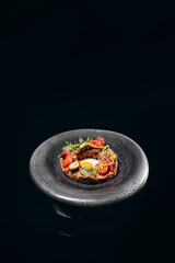 Beef tartare appetizer on the black background