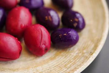 black, and red olives with lemon on a plate 