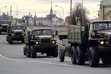 Russian automotive military equipment travels through the city. Guns tow trucks. Artillery on the...