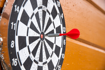 a close up of darts board and a dart hitting bullseye
