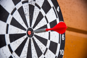 a close up of darts board and a dart hitting bullseye