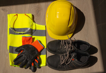 Personal protective equipment at work and construction. Helmet, reflective vest, gloves, goggles...