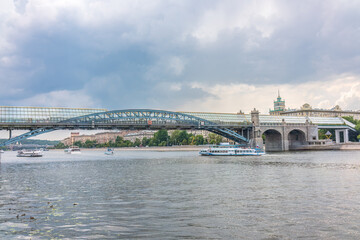 Naklejka premium View of the Moscow river embakment, Pushkinsky bridge and cruise ships at sunset.