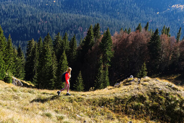A young woman during a hike in the mountains. A sunny summer day. Active tourism