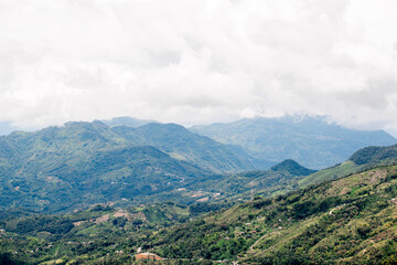 Fototapeta premium Scenic landscape of the lush green Andes Mountains in Colombia under a cloudy sky