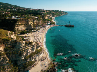 Italy, July 2023: panoramic aerial view from the drone of the caribbean sea and the cliff above the...
