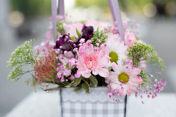 Bouquet of beautiful pink and white flowers, peonies, roses in craft package