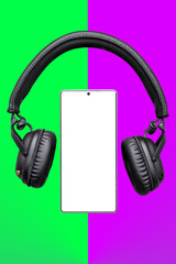 Mobile phone with empty screen and Headphones, Earphones on green and purple surface / Mobile phone screen mockup with black headphones / listening music, audio, podcast app