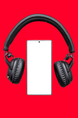 Mobile phone with empty screen and Headphones, Earphones on red surface / Mobile phone screen mockup with black headphones / listening music, audio, podcast app