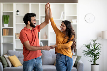 Domestic Romance. Loving Young Indian Spouses Dancing Together At Home
