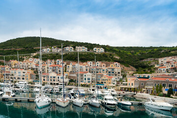 Fototapeta na wymiar Marina and buildings along the Mediterranean promenade in Boko Kotor Bay