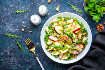 Waldorf salad with fresh apple, celery, lettuce, grilled chicken fillet, arugula and walnuts on...