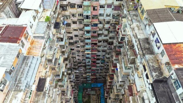 Yick Cheong and Yick Fat old apartment house exterior architecture in Hong Kong city, drone aerial view. Asian people residential life, transformer building or monster building travel landmark