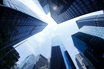 Obraz na płótnie Canvas New York City. Reflective skyscraper business office buildings. Bottom up view of big modern city urban landscape. Financial District