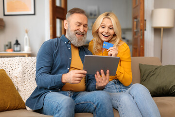 Senior Spouses Shopping With Tablet And Credit Card At Home